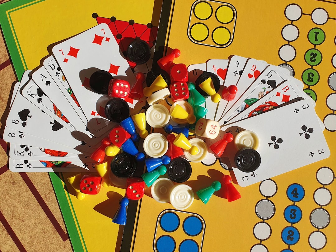 Machi Koro vs Kingdomino comparison showing cards and domino tiles on a table