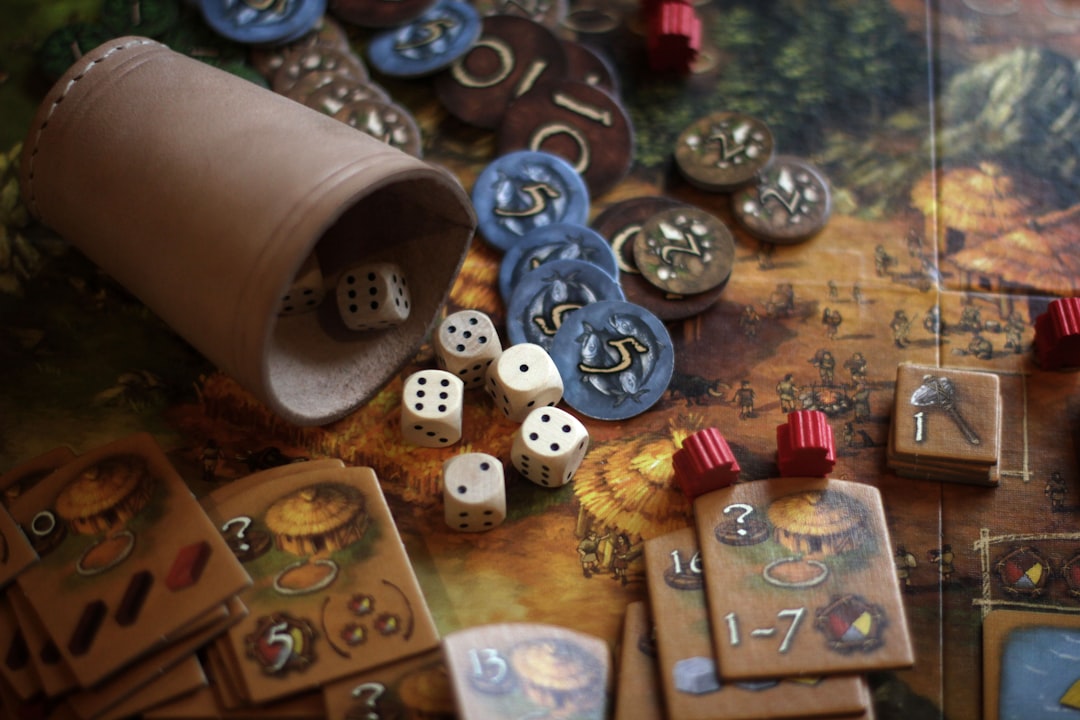 A close-up of a wooden worker piece being placed on a colorful board game map, representing worker placement games for beginners.